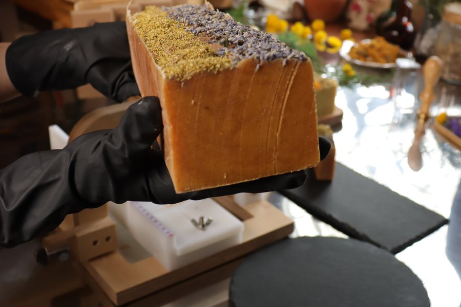 Handcrafted soap bar topped with lavender and dried herbs